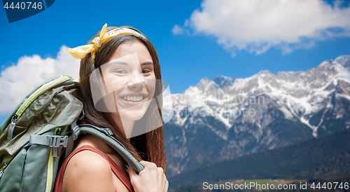 Image of happy woman with backpack over alps mountains