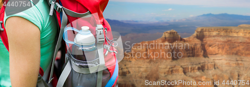 Image of close up of woman with water bottle in backpack