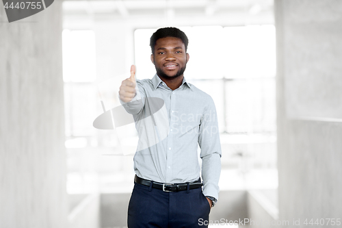 Image of african businessman at office showing thumbs up