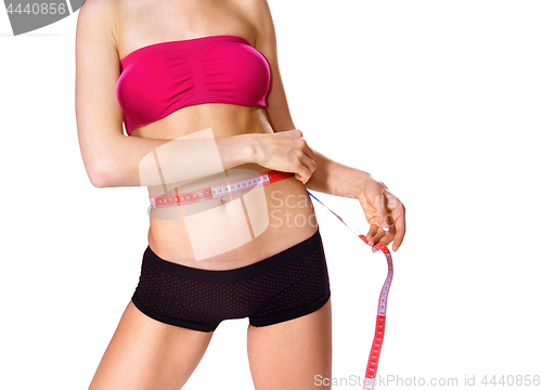 Image of measuring slim body of woman