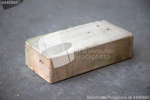 Image of old brick on grey concrete background