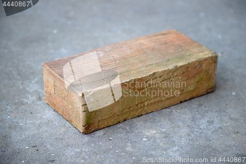 Image of old brick on grey concrete background