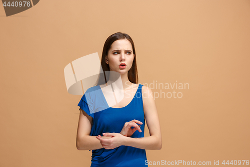 Image of Let me think. Doubtful pensive woman with thoughtful expression making choice against pastel background