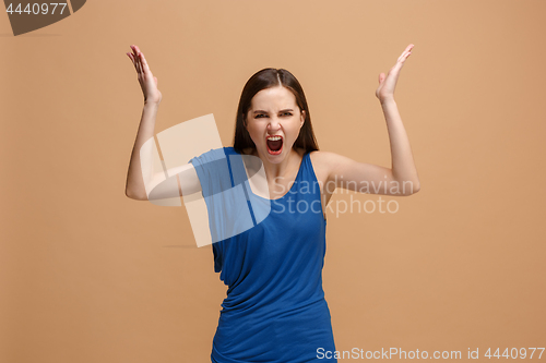 Image of The young emotional angry woman screaming on pastel studio background