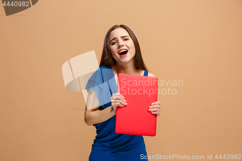 Image of Businesswoman with laptop on pastel studio