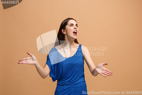 Image of The young emotional angry woman screaming on pastel studio background