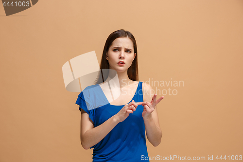 Image of Let me think. Doubtful pensive woman with thoughtful expression making choice against pastel background