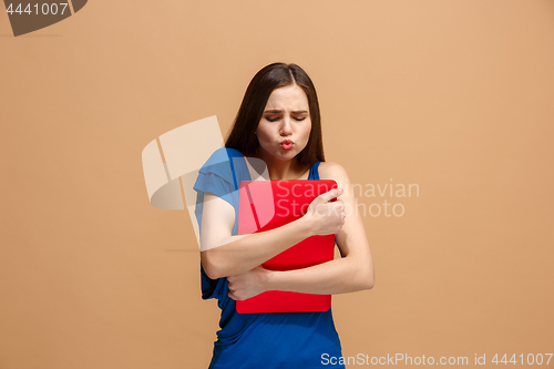 Image of Businesswoman hugging laptop on pastel studio