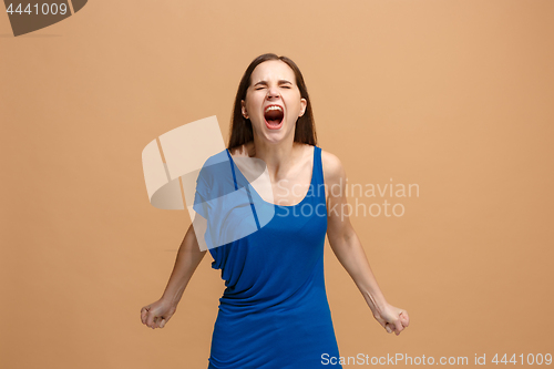 Image of The young emotional angry woman screaming on pastel studio background