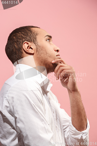 Image of Young serious thoughtful businessman. Doubt concept.