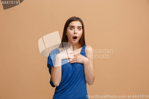 Image of Beautiful woman looking suprised isolated on pastel