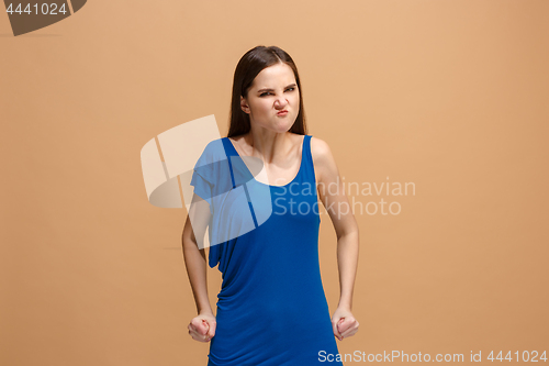 Image of Portrait of an angry woman looking at camera isolated on a pastel background