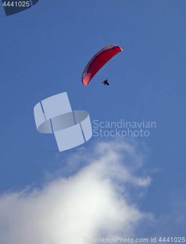 Image of Parasailing in a blue sky