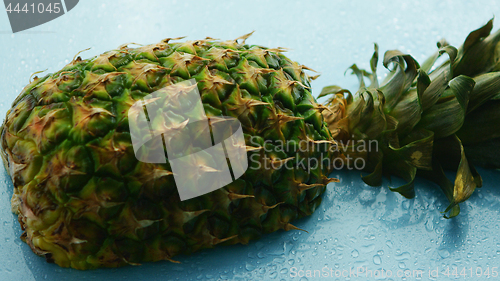 Image of Half of pineapple on wooden table 