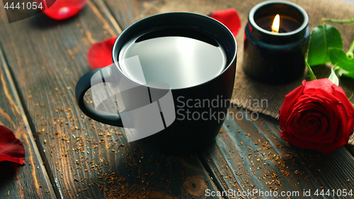 Image of Mug of drink and red roses