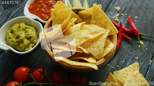 Image of Nachos and sauces on table 