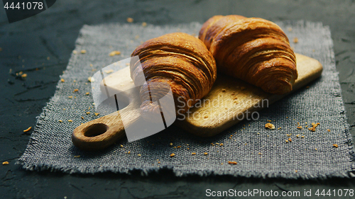Image of Fresh croissants on chopping board