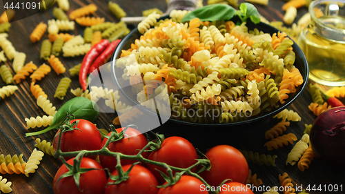 Image of Bowl with raw macaroni of different color