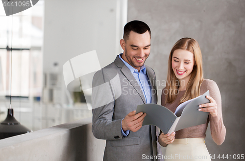 Image of businesswoman and businessman with folder