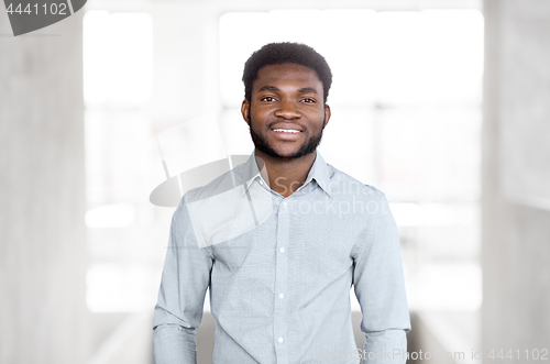 Image of smiling african american businessman at office