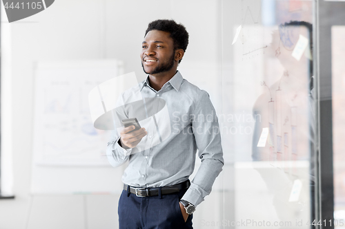 Image of businessman with smartphone at office