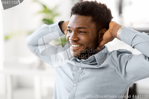 Image of smiling african american businessman at office