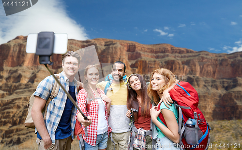 Image of happy travelers taking selfie at grand canyon