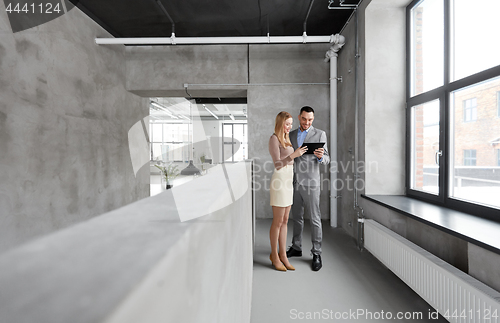 Image of businesswoman and businessman with tablet pc
