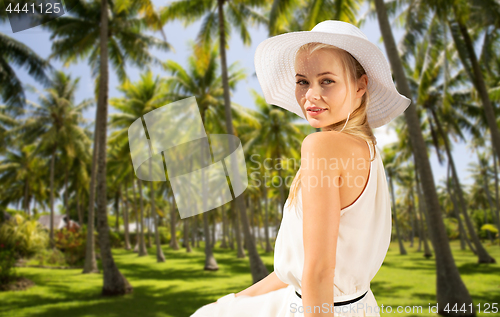 Image of beautiful woman enjoying summer over palm trees