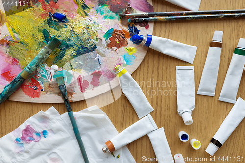 Image of palette, brushes and paint tubes on table