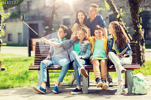 Image of happy teenage students taking selfie by smartphone