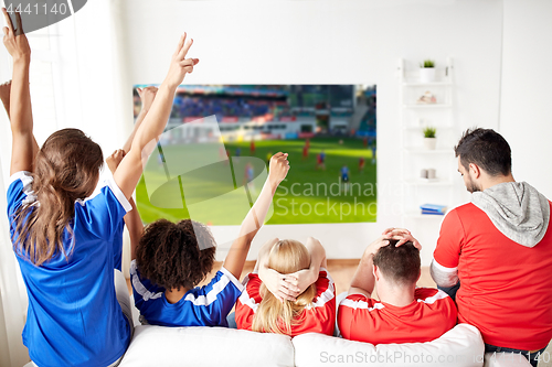 Image of happy friends or football fans watching soccer