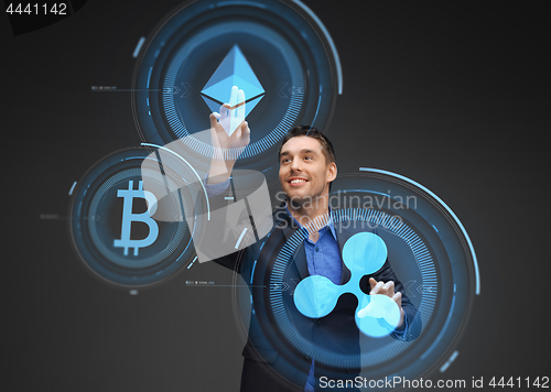 Image of businessman with cryptocurrency holograms