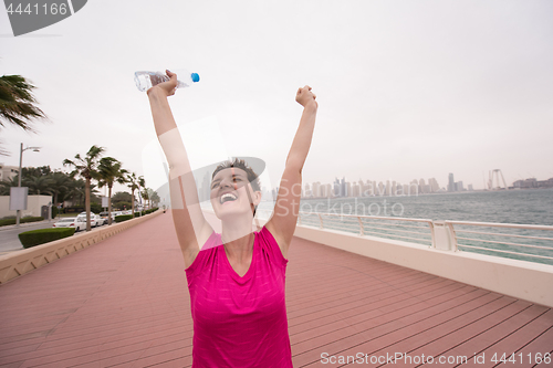 Image of young woman celebrating a successful training run