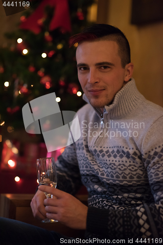 Image of Happy young man with a glass of champagne