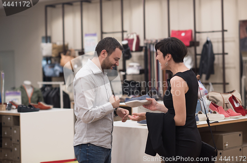 Image of couple chooses shoes At Shoe Store