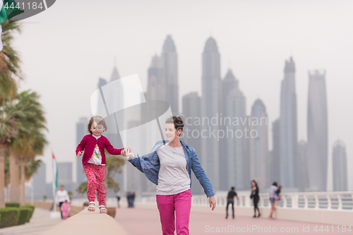 Image of mother and cute little girl on the promenade