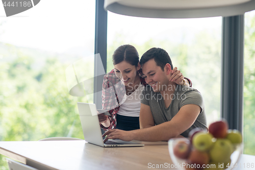 Image of happy young couple buying online