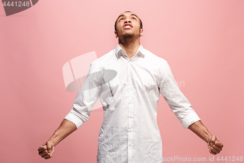 Image of The young emotional angry man screaming on pink studio background