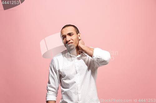 Image of Young man overwhelmed with a pain in the neck .