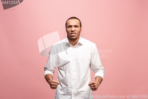 Image of The young emotional angry man screaming on pink studio background