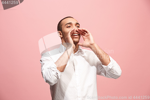 Image of Isolated on pink young casual man shouting at studio