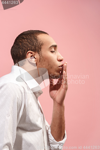 Image of Portrait of attractive man with kiss isolated over pink background