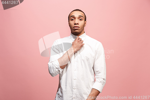 Image of Let me think. Doubtful pensive man with thoughtful expression making choice against pink background