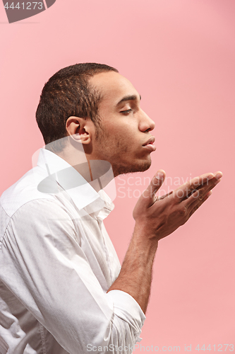 Image of Portrait of attractive man with kiss isolated over pink background