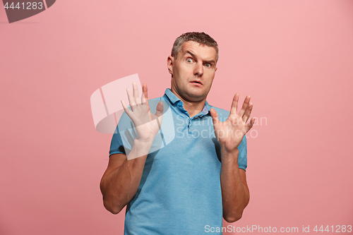 Image of Portrait of the scared man on pink