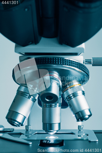 Image of Modern microscope with metal lens at laboratory.