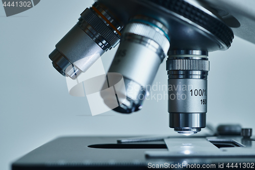 Image of Modern microscope with metal lens at laboratory.