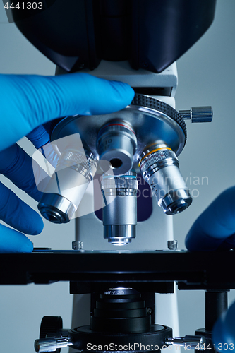 Image of Scientist hands with microscope