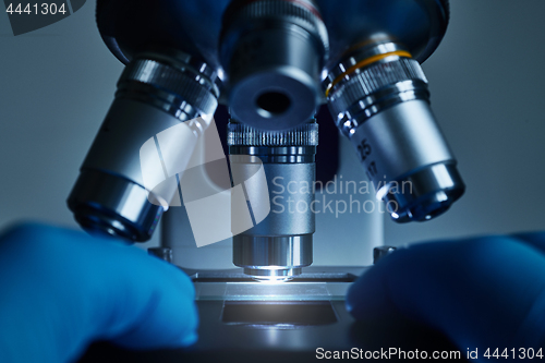 Image of Scientist hands with microscope